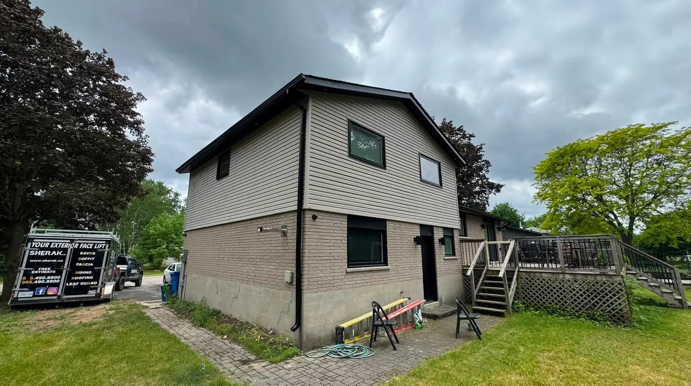 Completed upper storey and gable end clad in new siding, with the brick ground floor left as it was