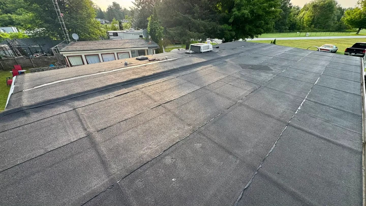 Edge of the finished membrane roof looking across to the neighbouring homes and gardens